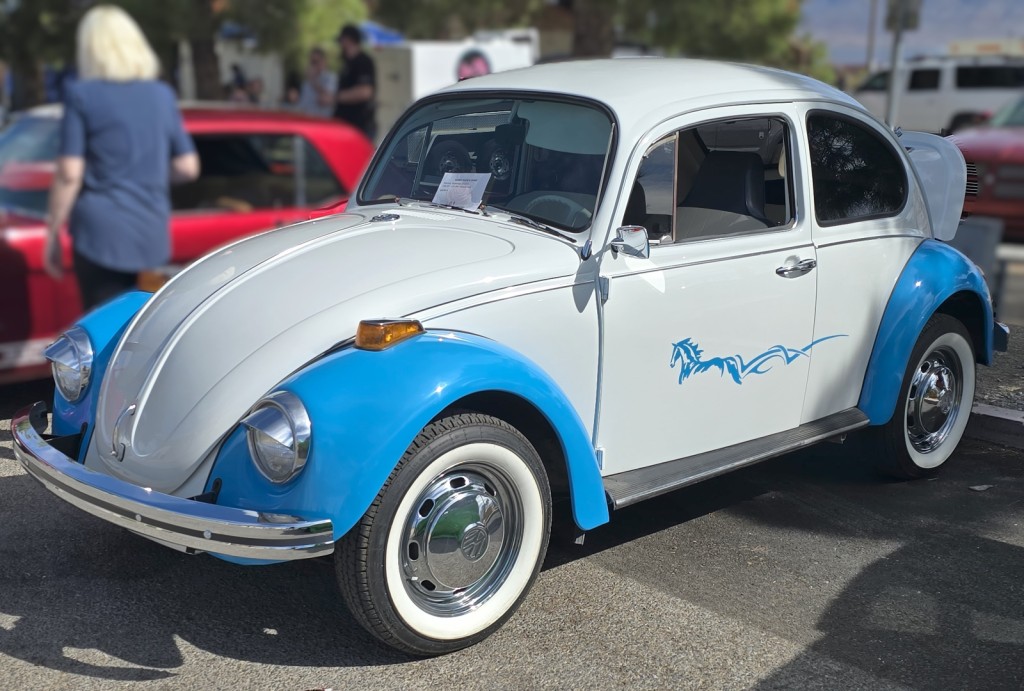 Pahrump Fall Festival Parade & Car Show - image of a restored VW Bug circa '60's with baby blue fenders and hooded headlights.