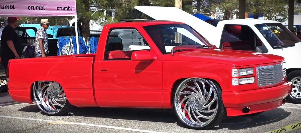 Pahrump Fall Festival Parade & Car Show - image of an red, conversion low-rider with hydraulics.