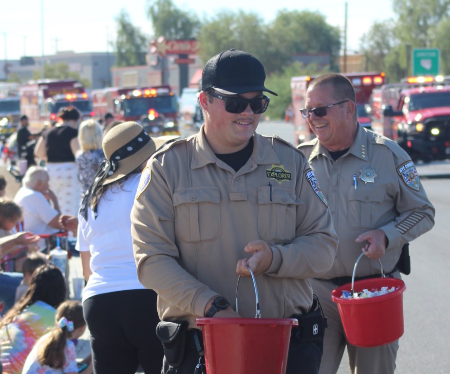 Pahrump Fall Festival Parade & Car Show - image of firemen and policemen distributing candy.