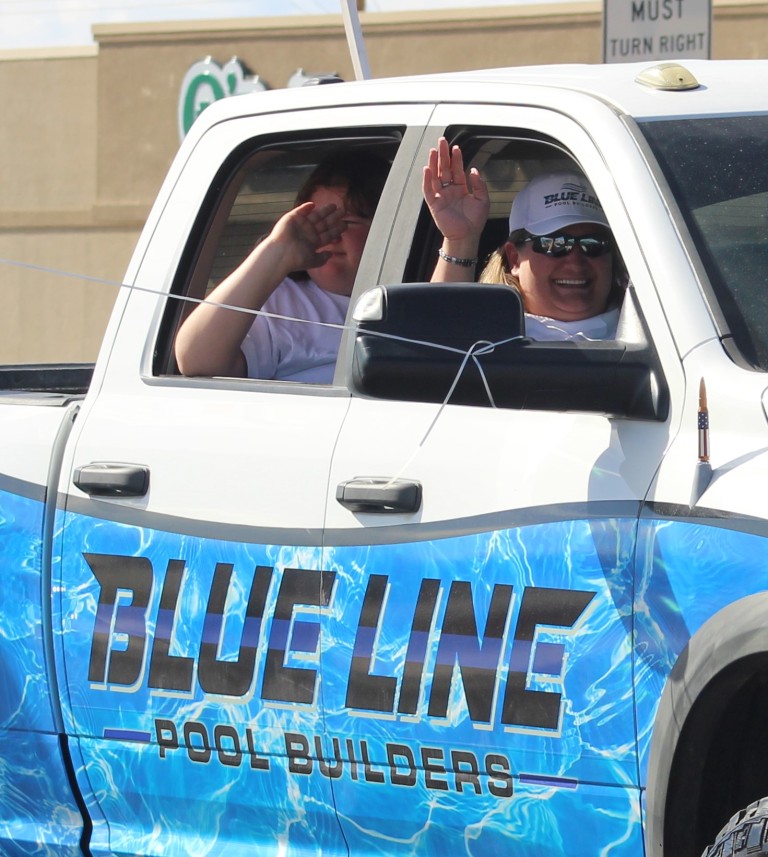 Pahrump Fall Festival Parade & Car Show - image of Blueline Pool Builders waving supporters.