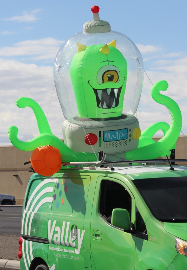 Pahrump Fall Festival Parade & Car Show - image of Valley Communications Association van with an inflatable alien on the roof.