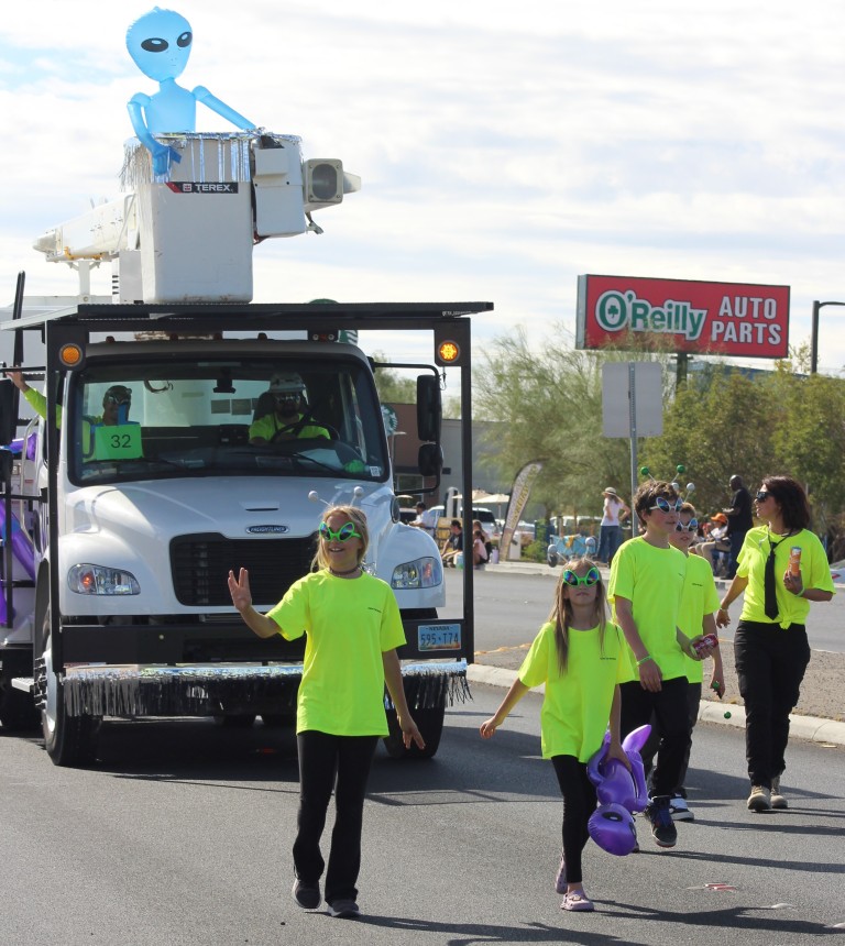 Pahrump Fall Festival Parade & Car Show - image of Men-In-Black Float and followers.
