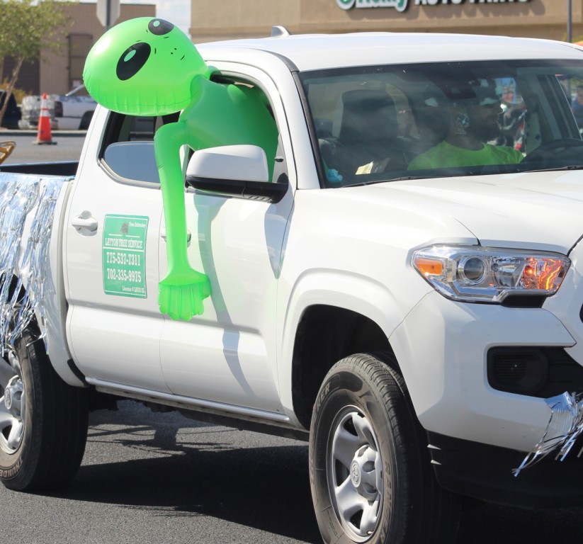 Pahrump Fall Festival Parade & Car Show - image of Layton Tree Service Float and large inflatable alien leaning out the window.