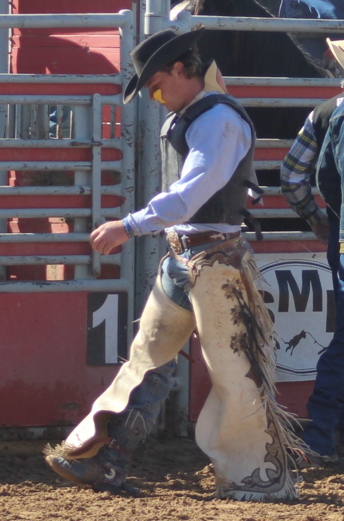 Bull riding event, dejected thrown rider heads out the gate at McCullough Arena, Pahrump NV as seen in: rodeo Fallon HS, rodeo Wells HS, rodeo Washoe HS, and rodeo Pahrump.