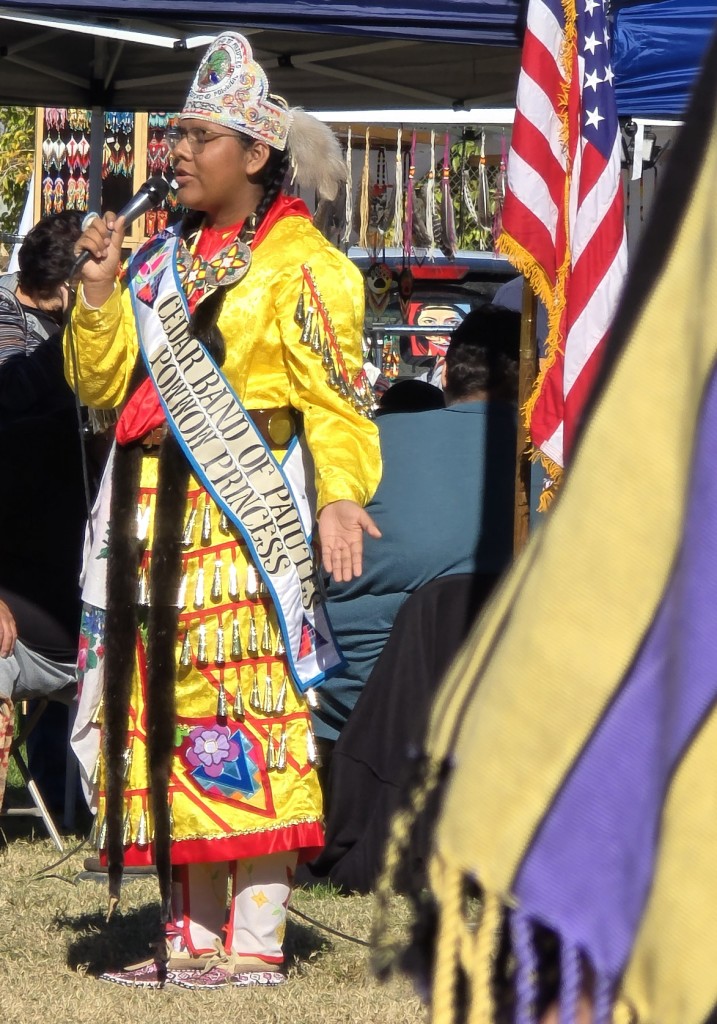 Princess for Cedar Band of Paiute, yellow Jingle Dress talks audience as seen in powwows: Cedar Band; Cedar City; Duck Valley; Elko; Ely; Fallon; Fort Mojave; Goshute; Las Vegas; Snow Mountain; Las Vegas Snow Mountain; Las Vegas Paiute Tribe; Las Vegas Snow Mountain Paiute; Las Vegas Snow Mountain Paiute Tribe; 33rd annual Las Vegas Snow Mountain Paiute; Moapa; Muckleshoot; Nevada Day; Numaga; Pahrump; Pahrump Valley; Pahrump Valley Social; Pahrump Social; Petrack; Petrack Park; Red Dress; Sacred Visions; San Marcos; San Marcos Apache; Stewart; Sycuan; UNLV; UNR; Univ. of Nev. Reno; and Walker River; & Western Navajo Fair.