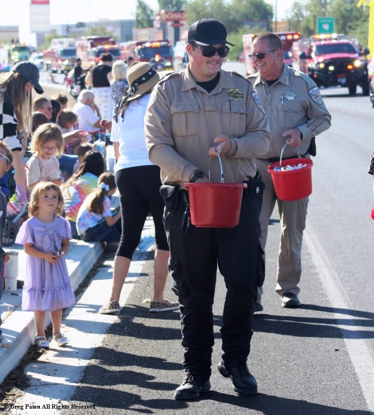 Pahrump Fall Festival Parade & Car Show highway patrolman passing out candy.